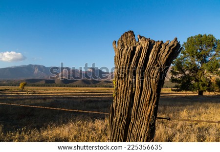 The old wooden fence post in the country before sunset.