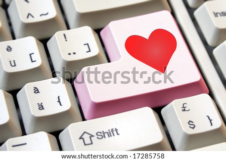 Love is the key. Heart on a pink computer enter key.