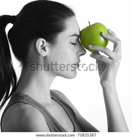 withe and black portrait with green apple