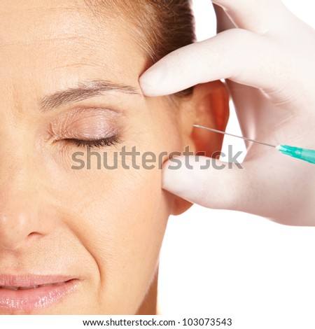 Elderly woman getting her eye wrinkles and crows feet removed