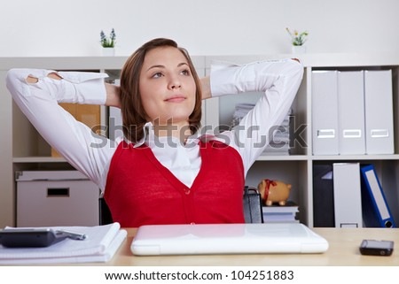 Relaxed female student at her desk leaning back