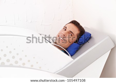 Man lying smiling in cabin ozone in spa