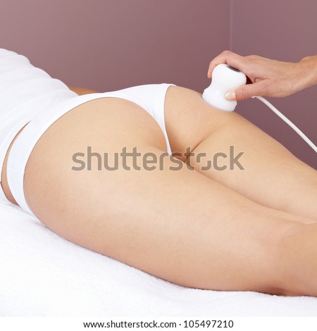 Woman getting electrical massage for muscle stimulation at buttocks