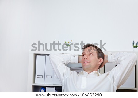 Relaxed business man leaning back in his office