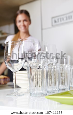 Clean dishes in kitchen with smiling female kitchen staff