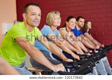 People exercising in a spinning course in fitness center