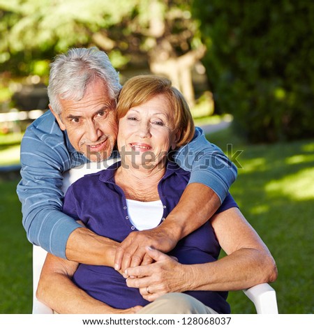 Happy senior couple in love in fall outside in a garden