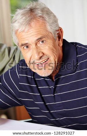 Portrait of a happy smiling elderly man in a retirement home