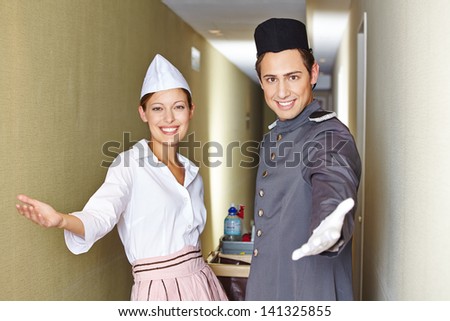 Friendly service team in hotel with open arms