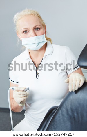 Dentist working with dental turbine and drill and mouthguard