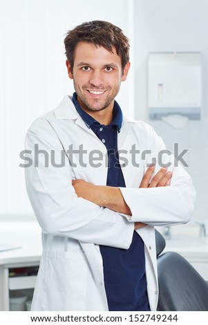 Smiling dentist with his arms crossed in his dental practice