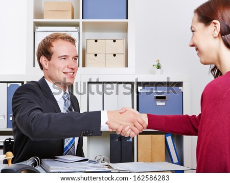 Woman thanking her financial adviser after a consultation in his office
