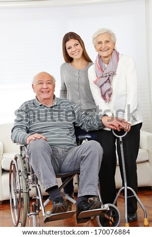 Happy family with senior citizen couple and granddaughter at home