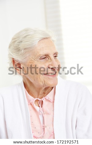 Face of a happy senior citizen woman with wrinkles in nursing home