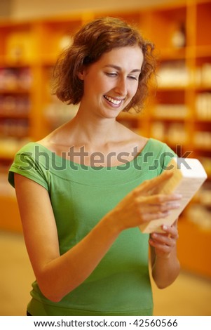 Customer in pharmacy reading information in medicine
