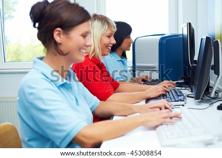 Female workers sitting on computer work stations