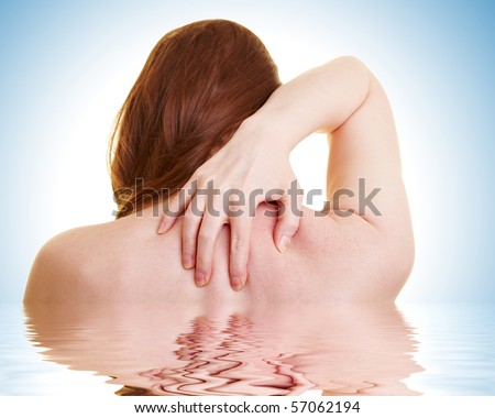 Woman in water touching her aching back