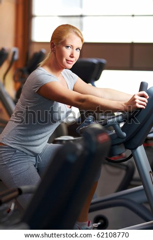 Woman in a gym using a home trainer