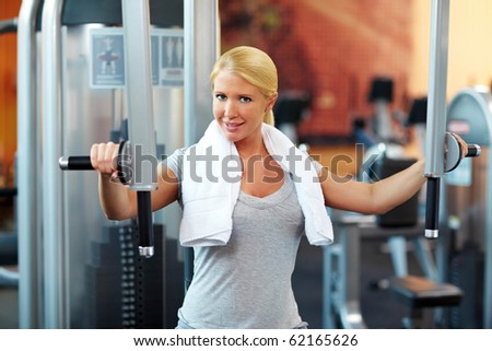 Female hand holding handle on training machine in gym