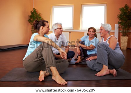 Fitness group having small talk in a gym