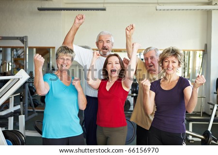 Happy elderly group in a gym cheering