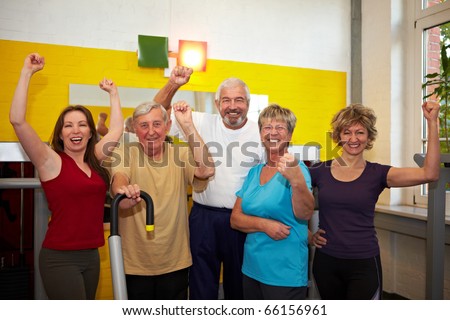 Mixed group with elderly people in a gym cheering