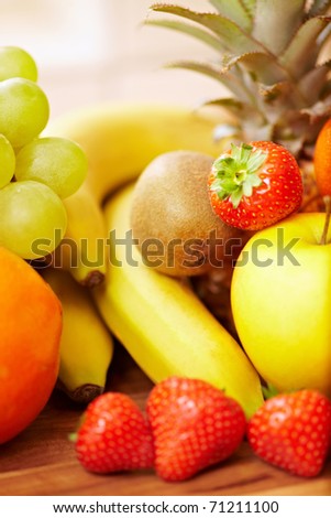 Different fresh fruits with strawberries, apple, bananas, kiwi, pinapple and others