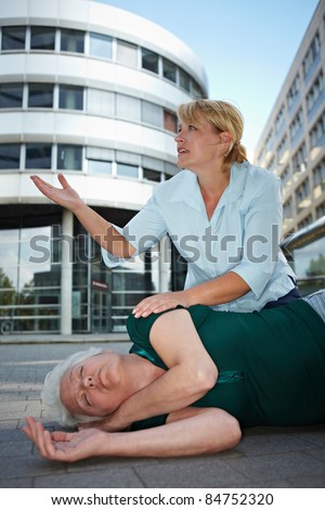 Passerby near helpless senior woman pleading for first aid help