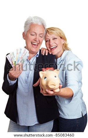 Two happy senior women with money and piggy bank