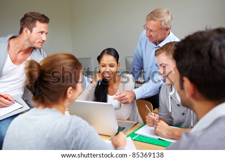 Teacher with students together in a college class