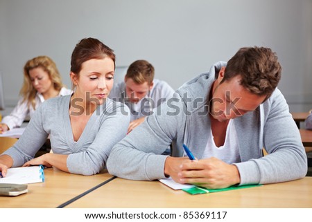 Female student trying to cheat at test in class