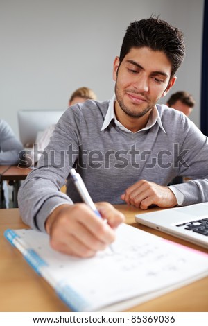 Student taking some notes in university class