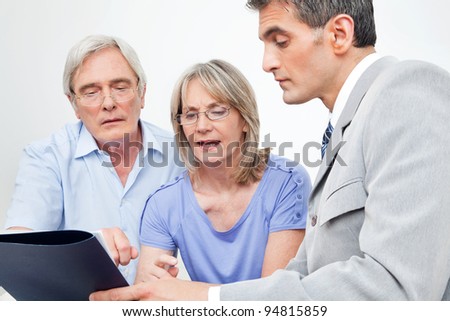 Senior couple getting financial advice from consultant at home