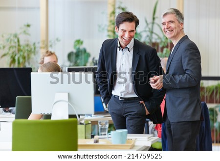 Two happy business people laughing during office break