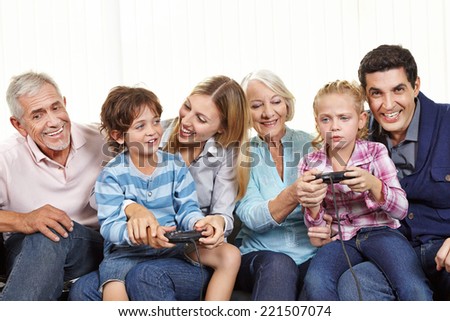 Happy family with controller playing video games on Smart TV in living room