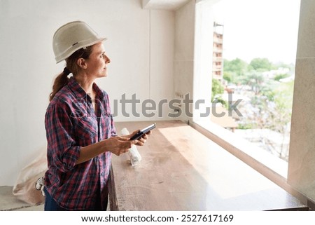 Similar – Image, Stock Photo foreman or architect working on mobile phone blueprints .construction site. Home improvement