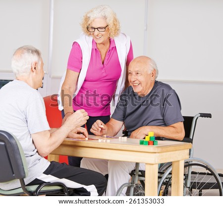 Happy senior people playing Bingo together in a nursing home