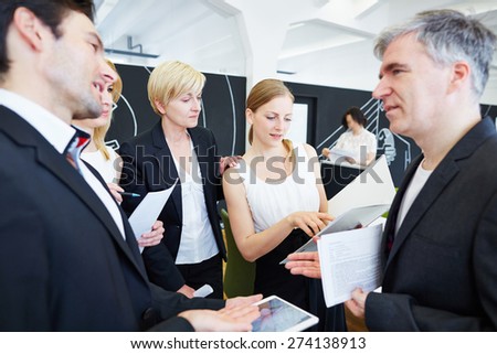 Team of business people in office talking to each other