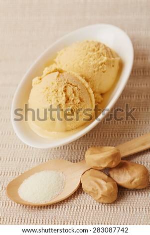 Salted caramel ice cream with toffee and salt on a spoon
