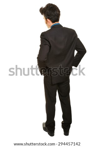 Business man standing from behind with both hands in his pockets