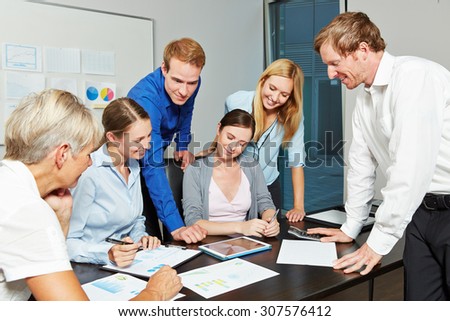 Young business people working together as a team in the office with tablet computer