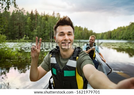 Similar – Foto Bild Zwei Männer in Rettungswesten beim Kanufahren auf einem Waldsee.