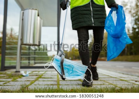 Image, Stock Photo Coronavirus garbage. Volunteers collecting used disposable medical masks and gloves near the bus stop and along the highway. The problem of environmental pollution during a pandemic COVID-19