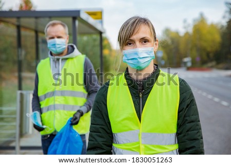 Similar – Image, Stock Photo Coronavirus garbage. Volunteers collecting used disposable medical masks and gloves near the bus stop and along the highway. The problem of environmental pollution during a pandemic COVID-19