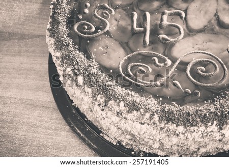 Delicious cake with number forty-five in vintage on a wooden background