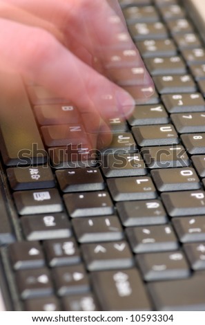 Fingers typing on a black laptop keyboard