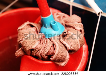 Red mop and bucket closeup