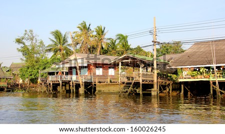 Stilt houses at a klong in Bangkok. Klongs are the canals, that branch off from Chao Phraya river, the big river of Bangkok. The klong is the only way to get to these houses.