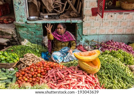 VARANASI, INDIA - FEBRUARY 19, 2014: A market seller in Varanasi, selling vegetables