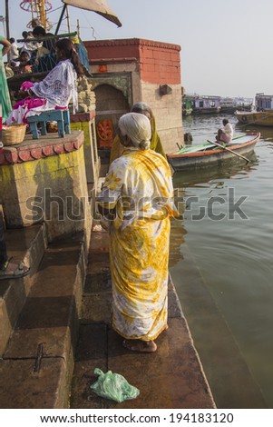 VARANASI; INDIA - FEBRUARY 21, 2014: woman in a colorful sari on the ghats of Varanasi.